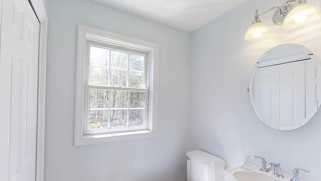 1079 North Brookfield Road Oakham, MA 01068 - Photo 23 of 40 a bathroom with a toilet and a mirror