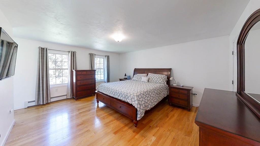 1079 North Brookfield Road Oakham, MA 01068 - Photo 25 of 40 a bedroom with a bed and wooden floor