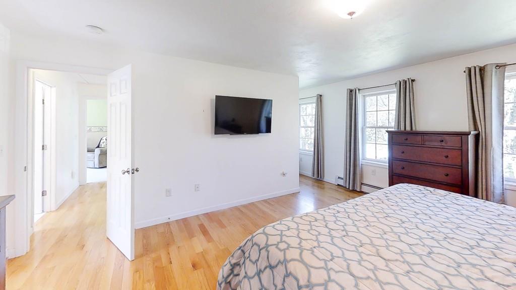 1079 North Brookfield Road Oakham, MA 01068 - Photo 26 of 40 a bedroom with a bed and a flat screen tv