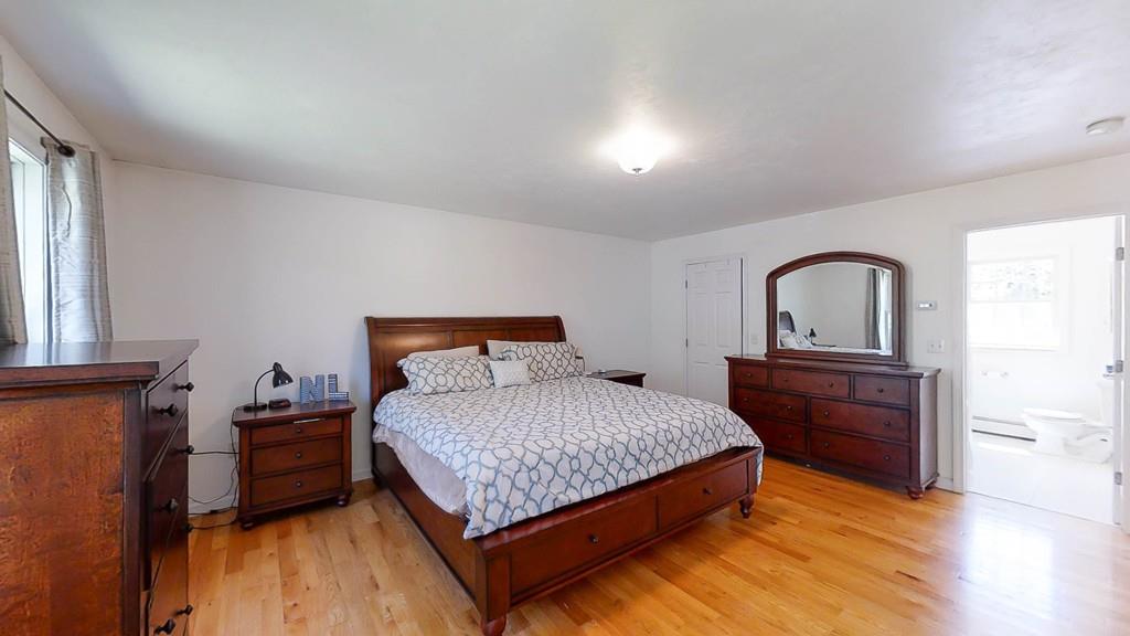 1079 North Brookfield Road Oakham, MA 01068 - Photo 27 of 40 a bedroom with a bed and wooden floor