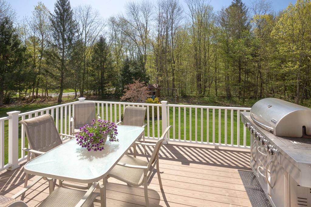1079 North Brookfield Road Oakham, MA 01068 - Photo 38 of 40 a view of a chairs and table on the deck