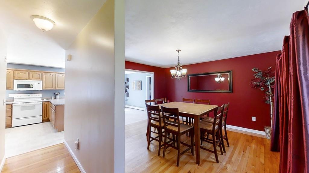 1079 North Brookfield Road Oakham, MA 01068 - Photo 5 of 40 a view of a dining room with furniture and chandelier