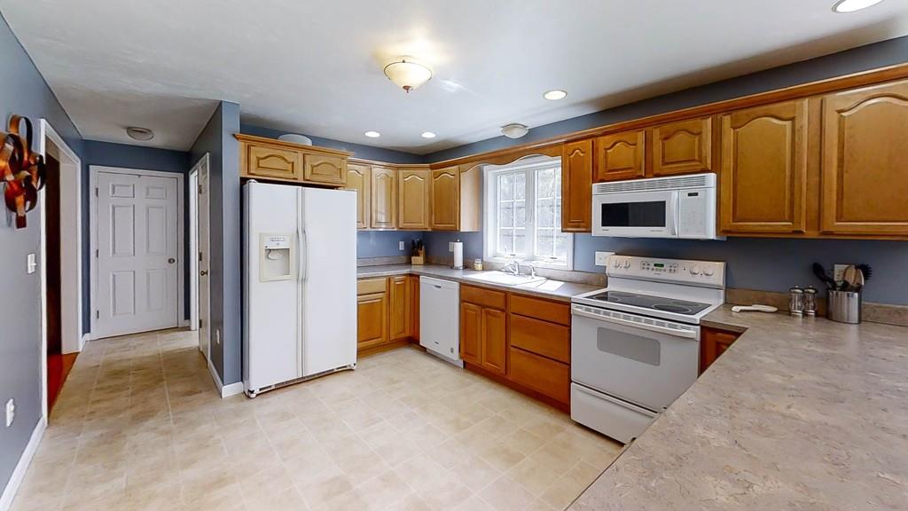 1079 North Brookfield Road Oakham, MA 01068 - Photo 9 of 40 a kitchen with stainless steel appliances granite countertop a refrigerator stove top oven and sink