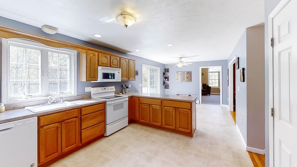 1079 North Brookfield Road Oakham, MA 01068 - Photo 10 of 40 a large kitchen with stainless steel appliances granite countertop a sink and cabinets with wooden floor