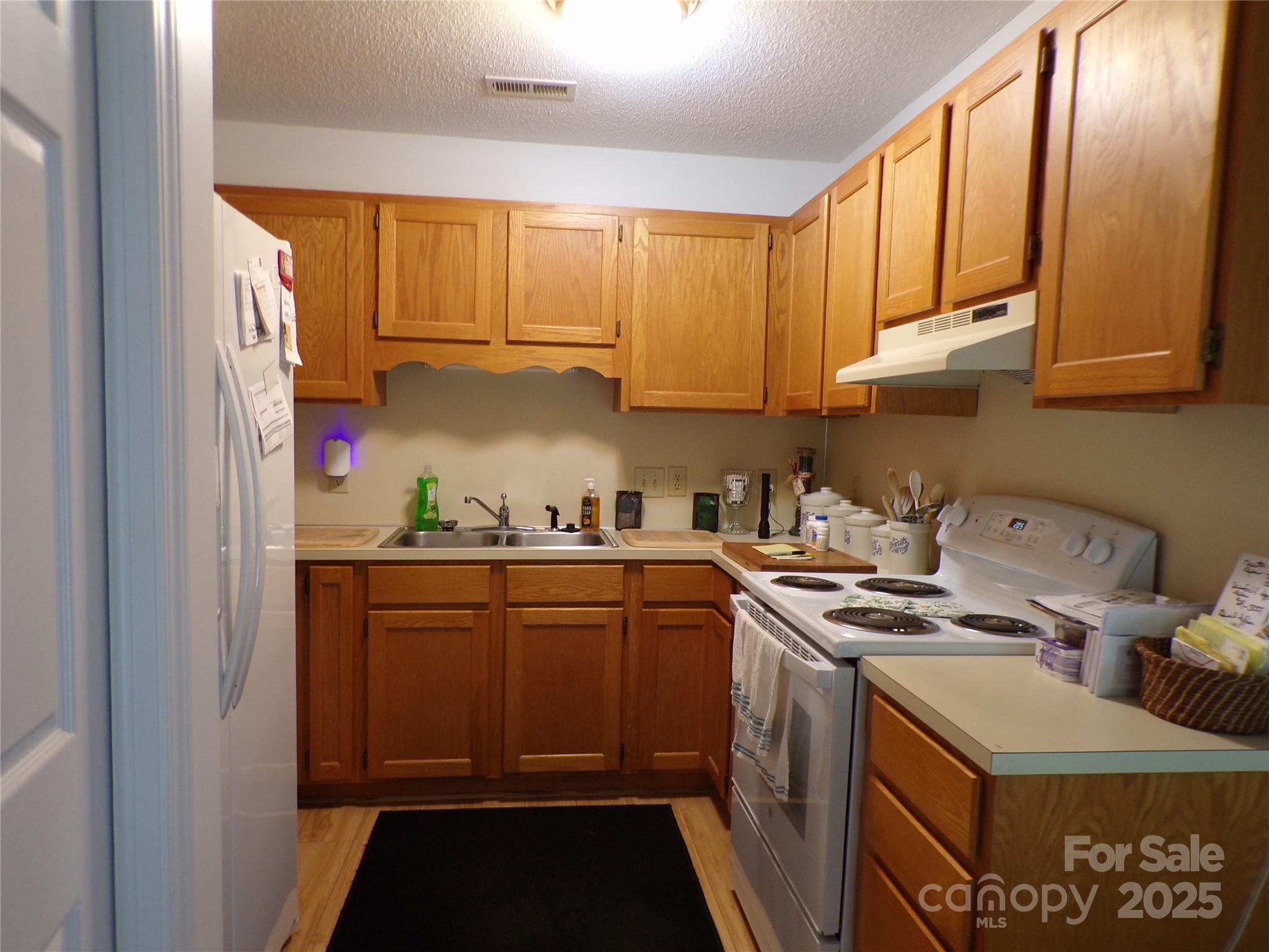 319 7th St Place Southwest, Unit E5 Conover, NC 28613 - Photo 9 of 15 a kitchen with stainless steel appliances granite countertop a stove a sink and a refrigerator