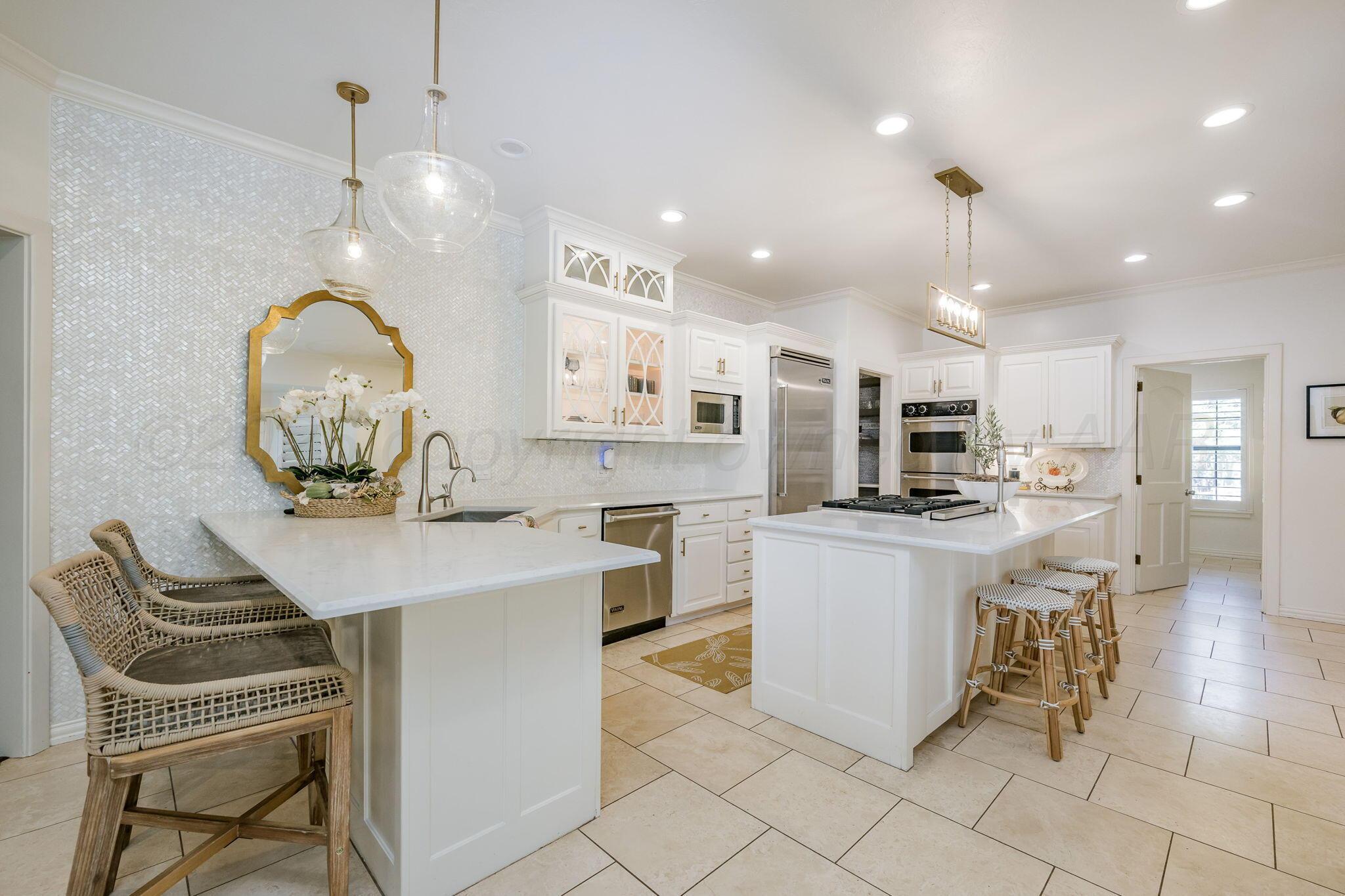 170 Dolphin Terrace Amarillo, TX 79118 - Photo 13 of 56 a kitchen with stainless steel appliances kitchen island granite countertop a stove a sink a dining table and chairs