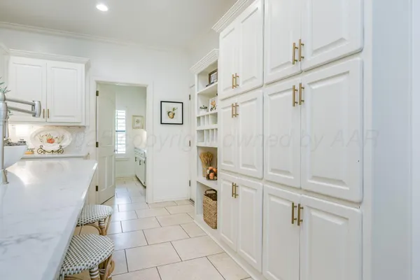 a view of a kitchen with refrigerator and window