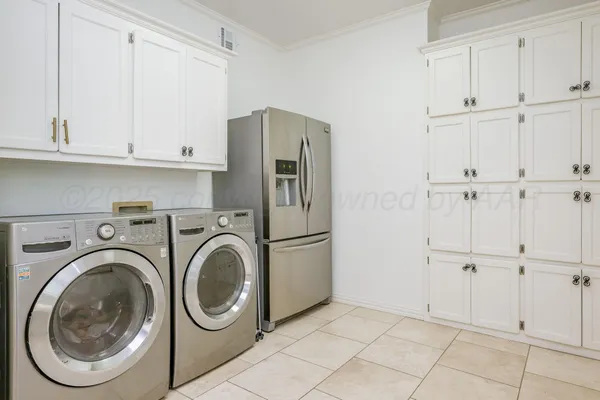 a view of kitchen and refrigerator