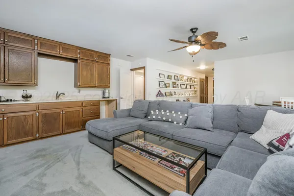 a view of a livingroom with furniture and a ceiling fan