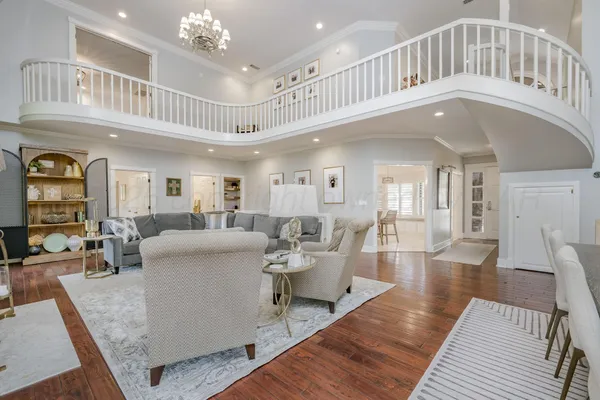a living room with furniture and a chandelier