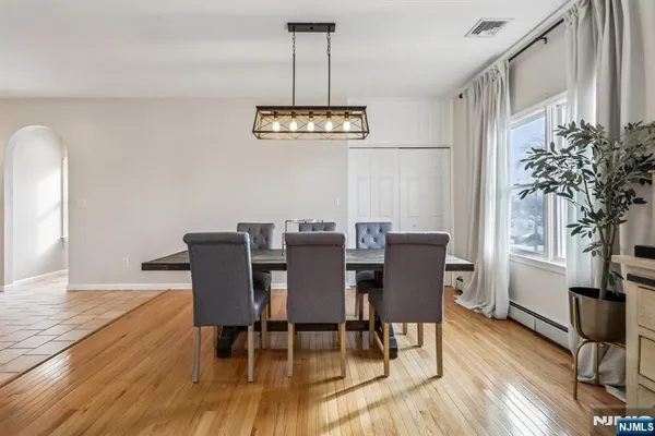 a view of a dining room with furniture window and wooden floor