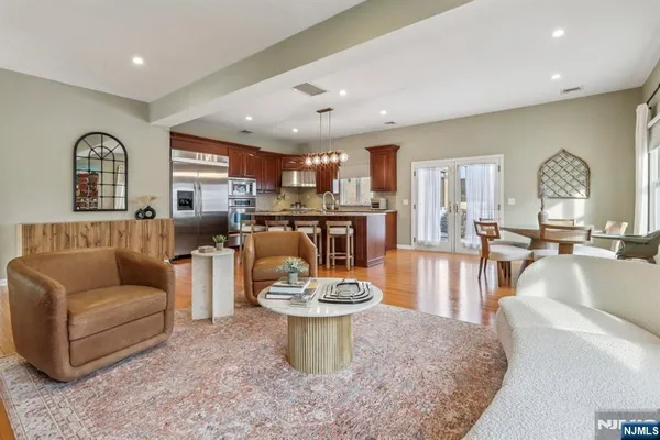 a living room with kitchen island furniture and a wooden floor