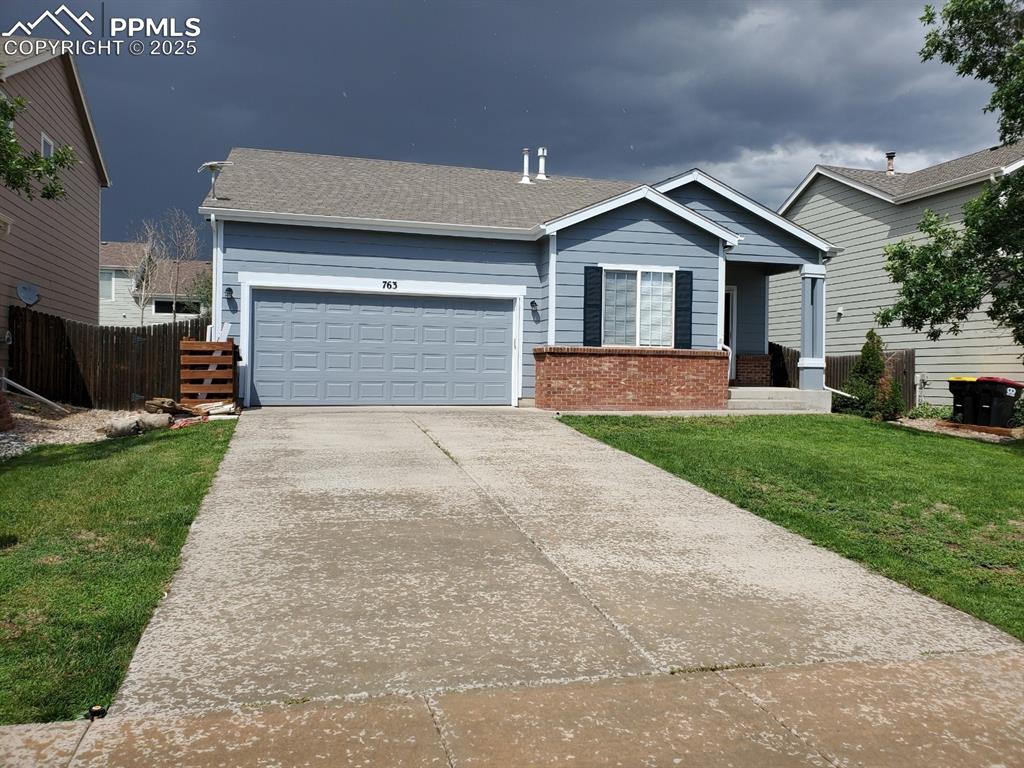 a front view of a house with a yard and garage