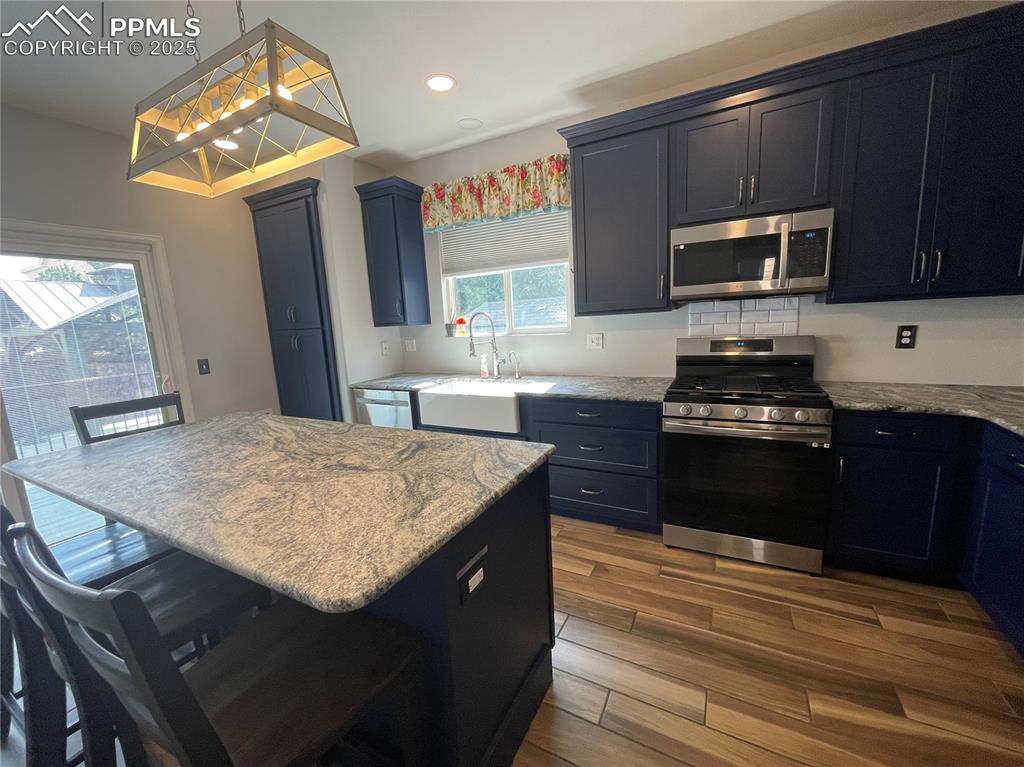 7631 Coffee Road Peyton, CO 80831 - Photo 11 of 28 a kitchen with a sink appliances and cabinets