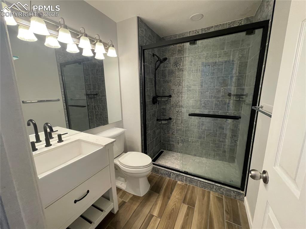 7631 Coffee Road Peyton, CO 80831 - Photo 13 of 28 a bathroom with a sink toilet and shower