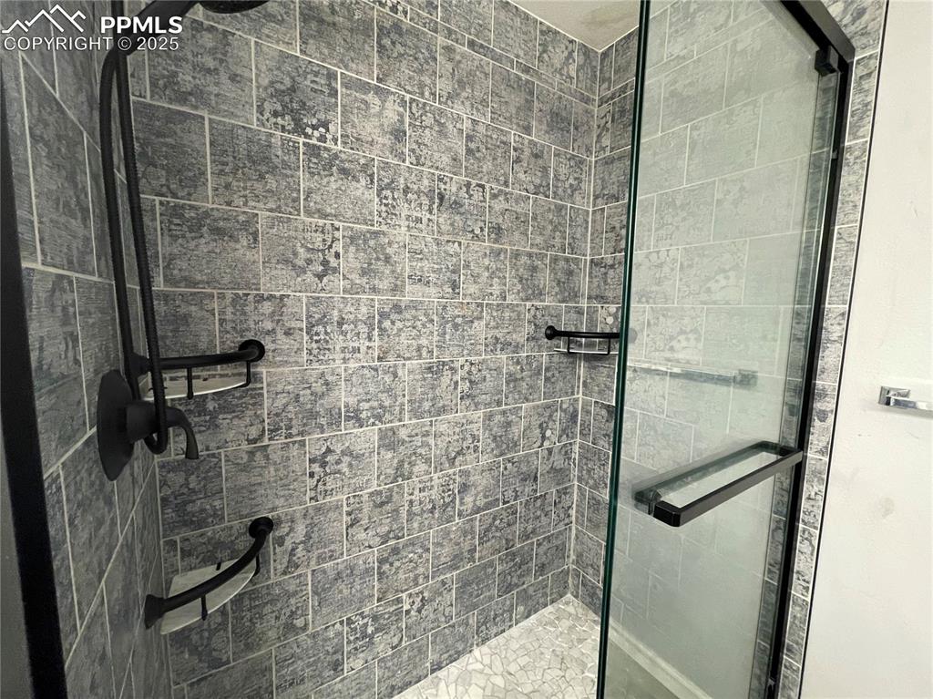 7631 Coffee Road Peyton, CO 80831 - Photo 14 of 28 a bathroom with a shower