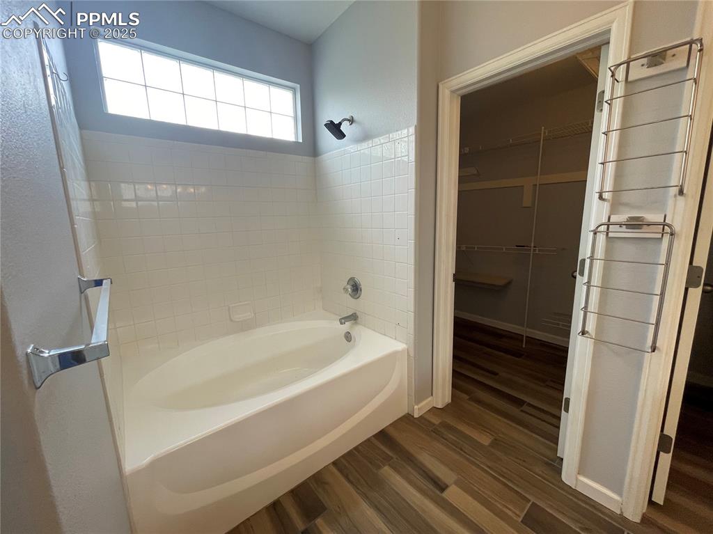 7631 Coffee Road Peyton, CO 80831 - Photo 23 of 28 a bathroom with a bathtub and a shower