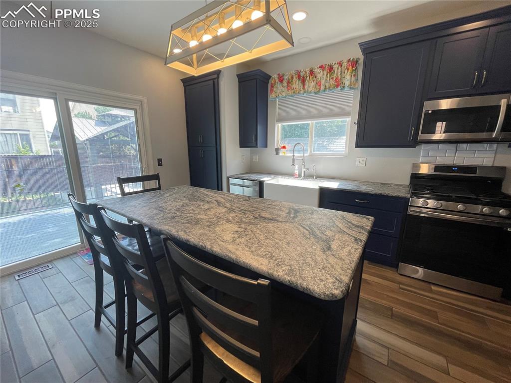 7631 Coffee Road Peyton, CO 80831 - Photo 8 of 28 a kitchen with a wooden table and chairs