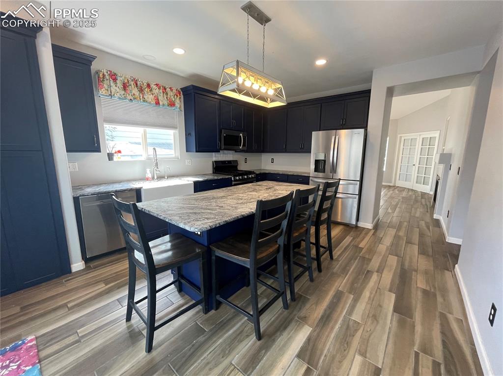 7631 Coffee Road Peyton, CO 80831 - Photo 9 of 28 a view of a dining room with furniture window and wooden floor