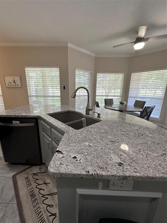 1425 Pecan Hill Road Stephenville, TX 76401 - Photo 12 of 40 a kitchen with kitchen island granite countertop a sink a stove a counter space and a window