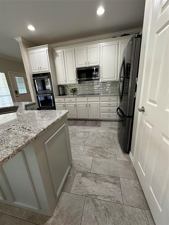 1425 Pecan Hill Road Stephenville, TX 76401 - Photo 14 of 40 a kitchen with stainless steel appliances granite countertop a refrigerator a stove a sink and a microwave