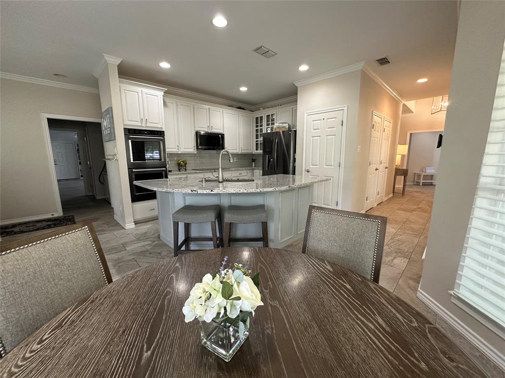 1425 Pecan Hill Road Stephenville, TX 76401 - Photo 15 of 40 a living room with furniture and a dining table with kitchen view