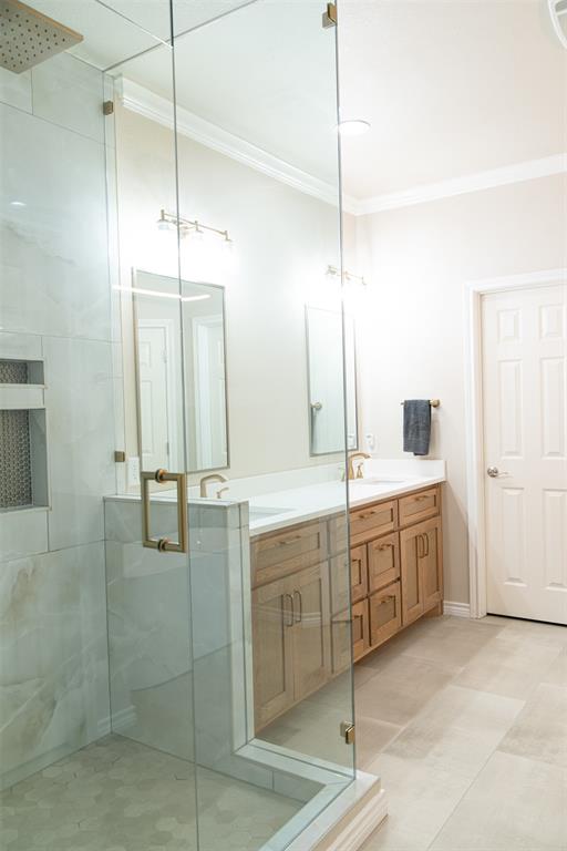 1425 Pecan Hill Road Stephenville, TX 76401 - Photo 21 of 40 a large bathroom with a double vanity sink a large mirror and shower