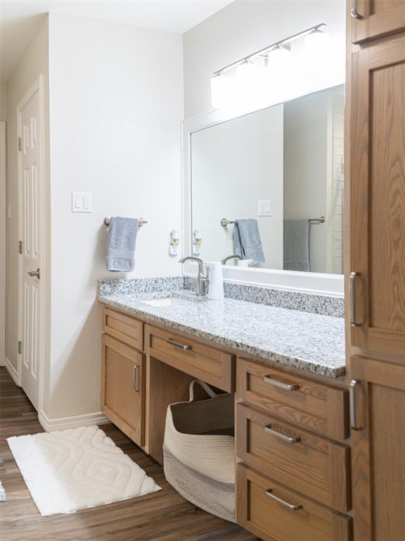 1425 Pecan Hill Road Stephenville, TX 76401 - Photo 27 of 40 a bathroom with a granite countertop sink and a mirror
