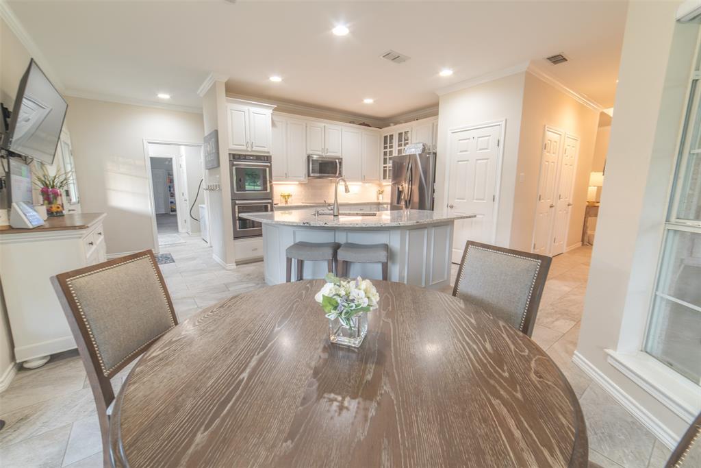 1425 Pecan Hill Road Stephenville, TX 76401 - Photo 33 of 40 a view of a dining room with furniture a rug and wooden floor