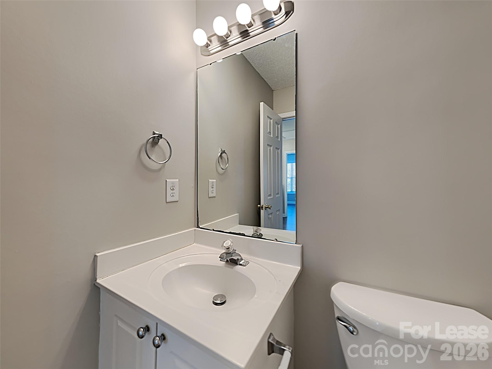 2006 Proverbs Court Monroe, NC 28110 - Photo 15 of 16 a bathroom with a sink a toilet and mirror