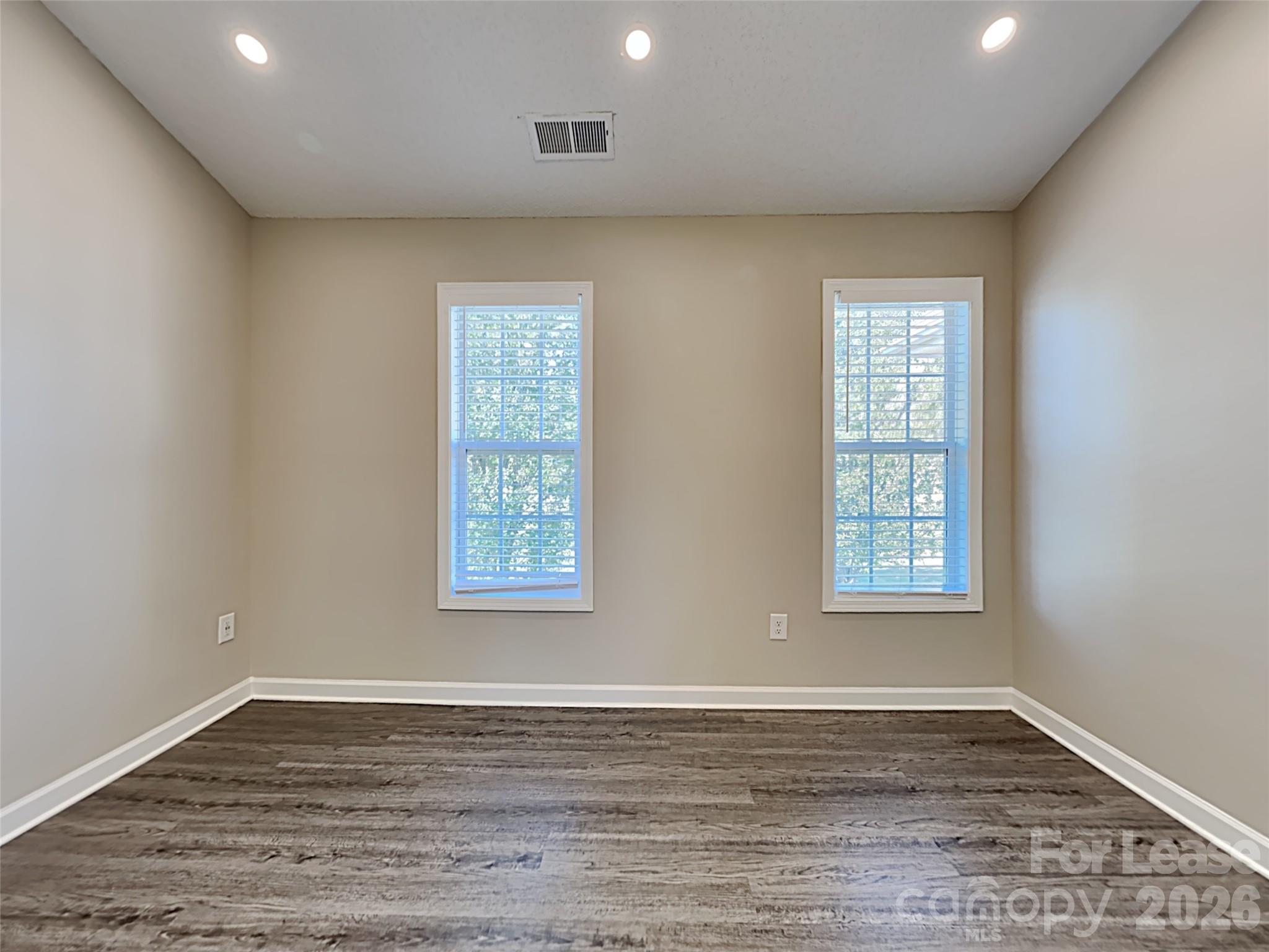 2006 Proverbs Court Monroe, NC 28110 - Photo 9 of 16 an empty room with wooden floor and windows