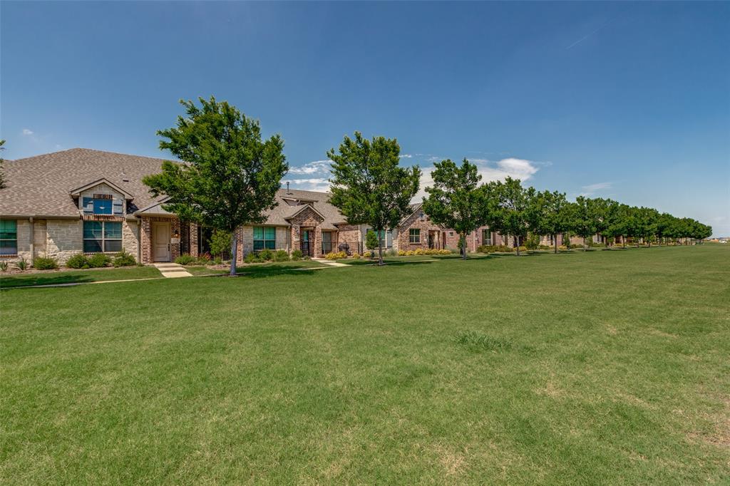 a view of a garden with a house in the background