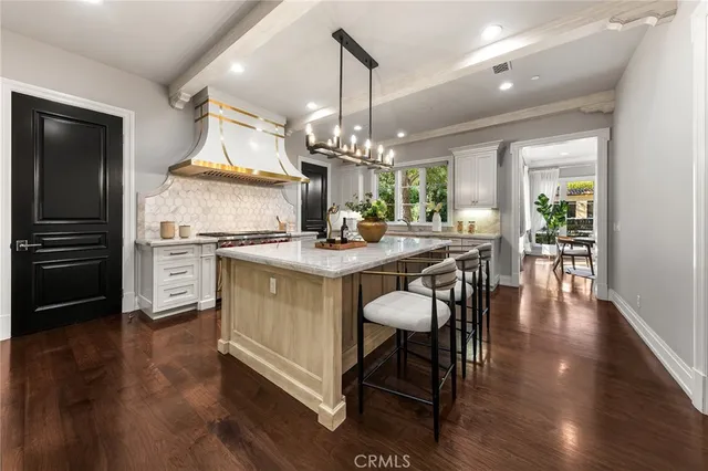a kitchen with granite countertop a sink stainless steel appliances and cabinets