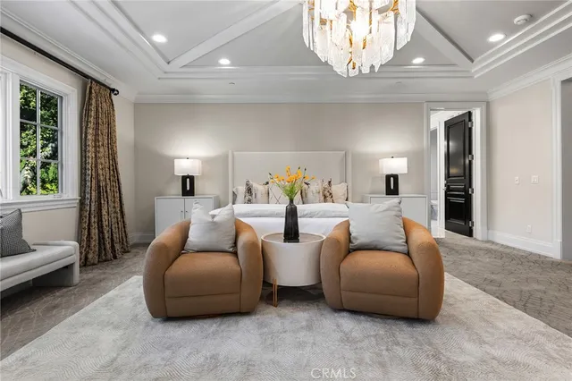 a living room with furniture a fireplace and a large window