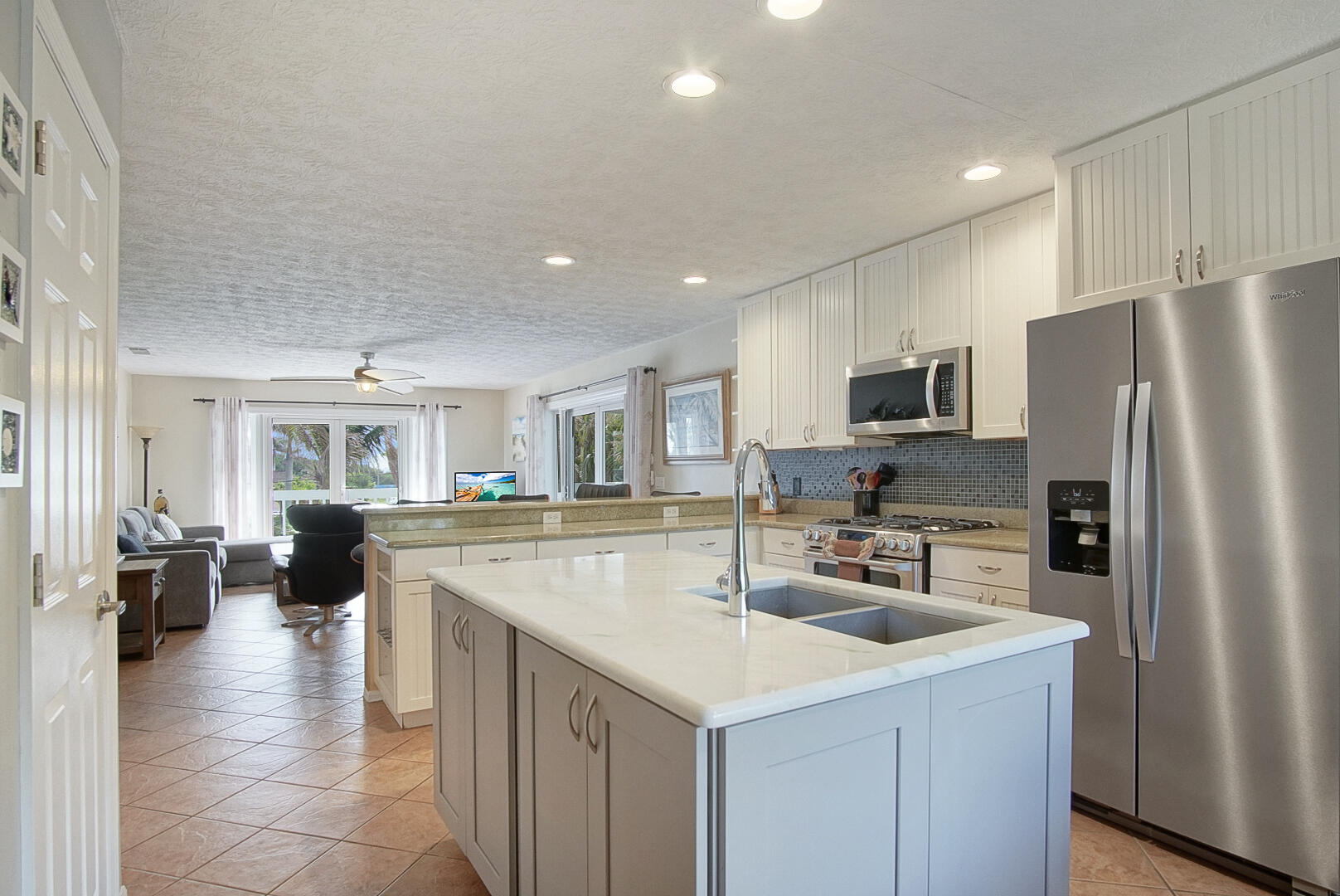 413 Hernando Street Fort Pierce, FL 34949 - Photo 11 of 43 a kitchen with a sink a counter top space and stainless steel appliances