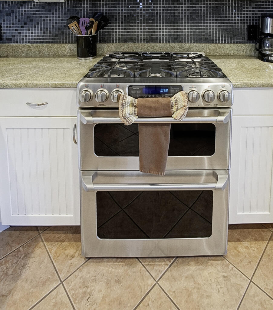 413 Hernando Street Fort Pierce, FL 34949 - Photo 13 of 43 a stove top oven sitting inside of a kitchen