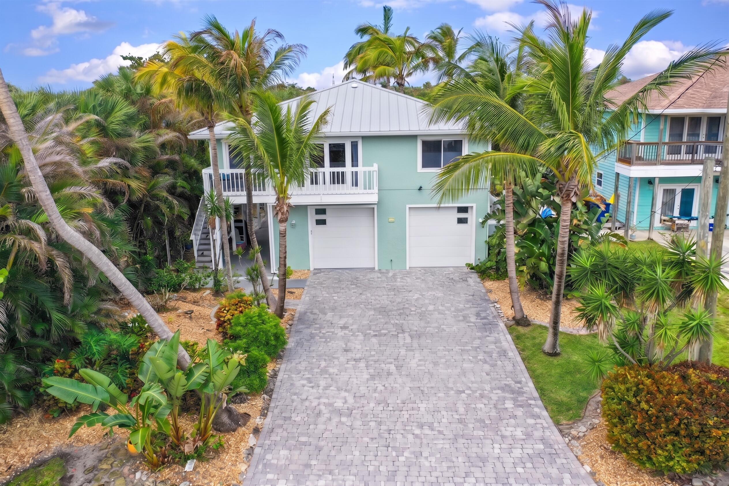 413 Hernando Street Fort Pierce, FL 34949 - Photo 2 of 43 a front view of a house with a garden