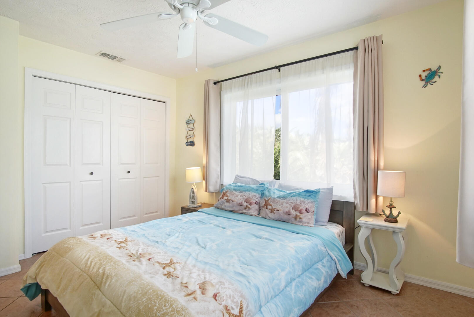 413 Hernando Street Fort Pierce, FL 34949 - Photo 23 of 43 a bedroom with a bed and a chandelier