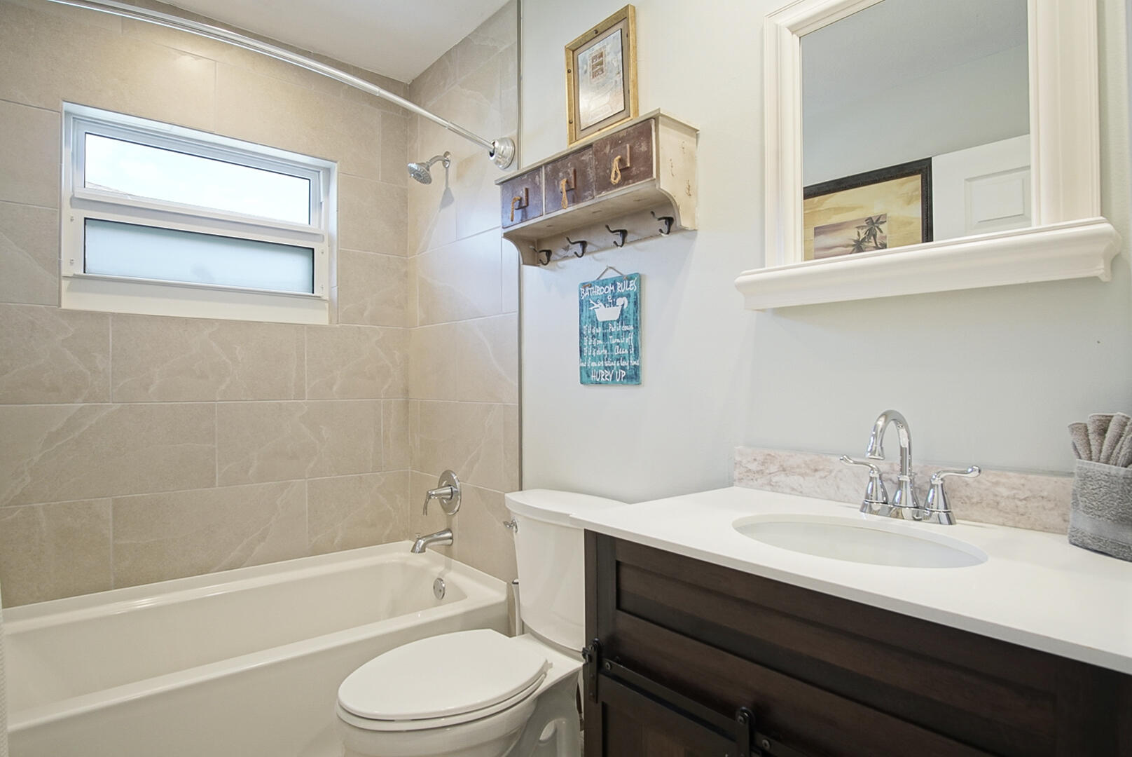 413 Hernando Street Fort Pierce, FL 34949 - Photo 24 of 43 a bathroom with a sink toilet a mirror and shower