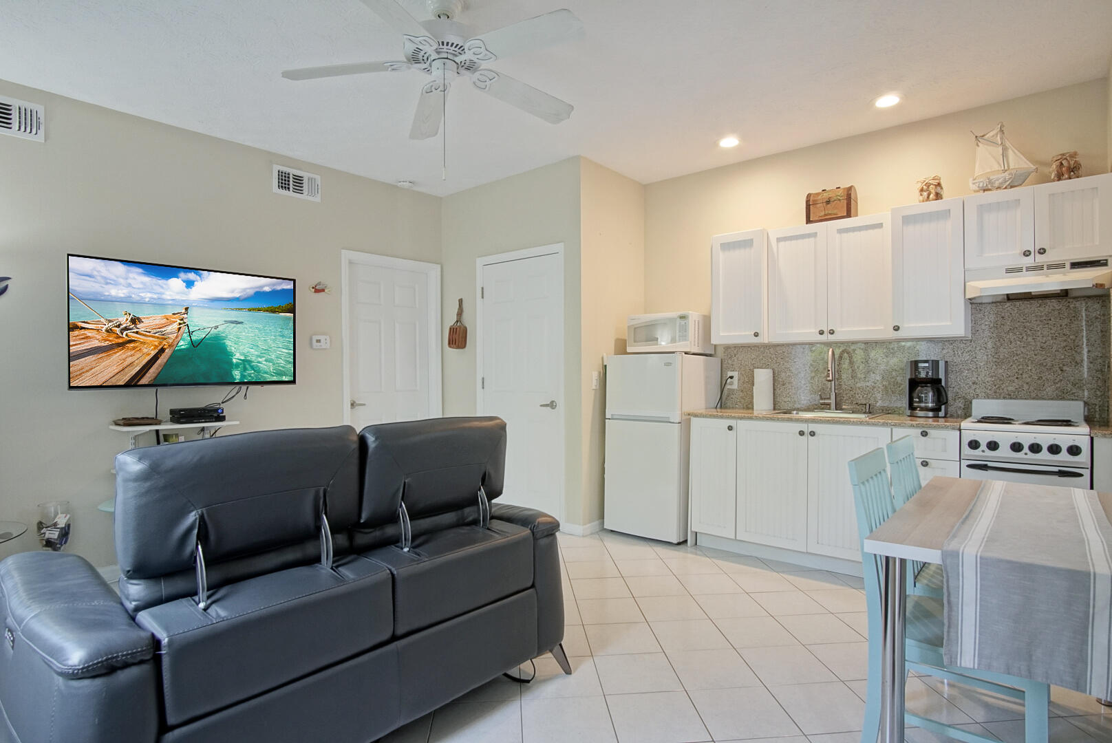 413 Hernando Street Fort Pierce, FL 34949 - Photo 27 of 43 a living room with furniture and a flat screen tv