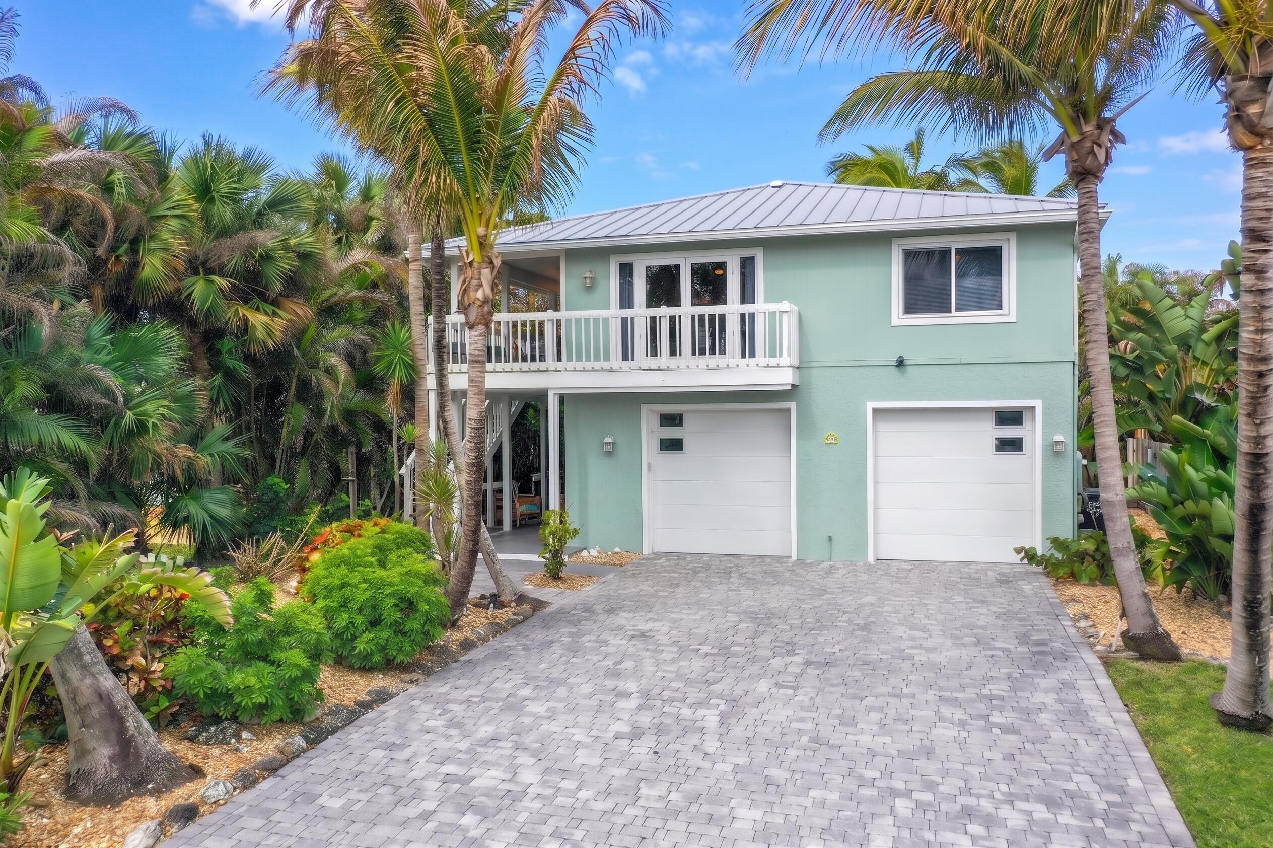 413 Hernando Street Fort Pierce, FL 34949 - Photo 3 of 43 a front view of a house with a garden