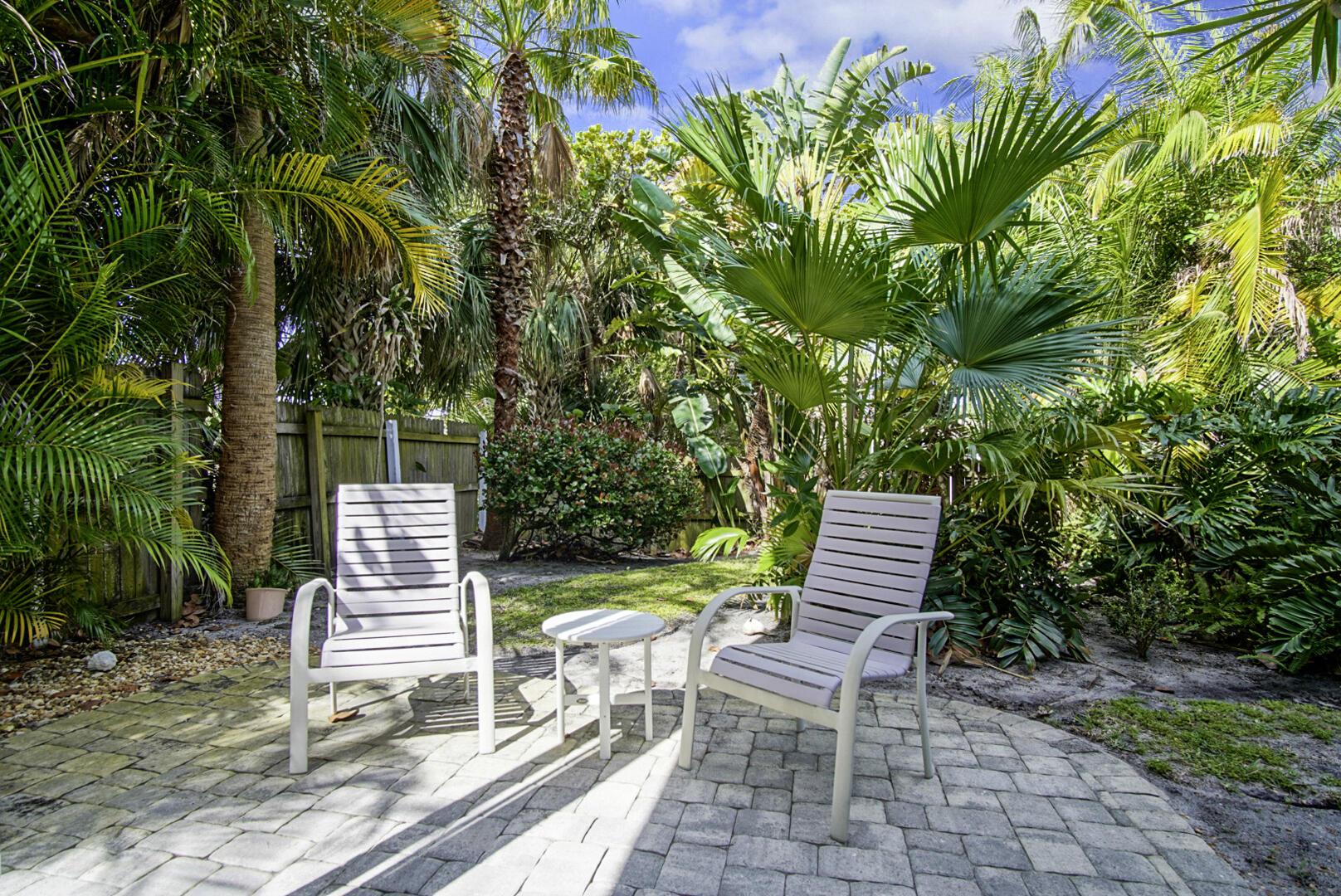 413 Hernando Street Fort Pierce, FL 34949 - Photo 34 of 43 a view of a chair and tables in the backyard of the house