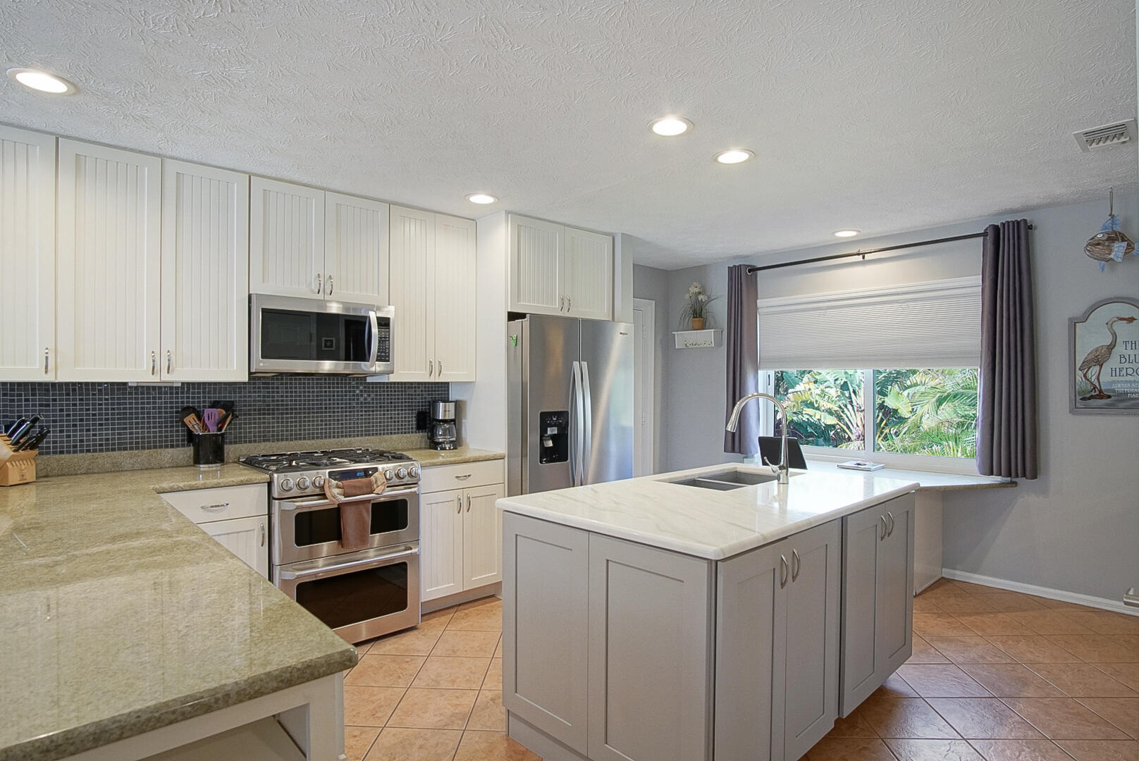 413 Hernando Street Fort Pierce, FL 34949 - Photo 10 of 43 a kitchen with a stove a sink and a refrigerator