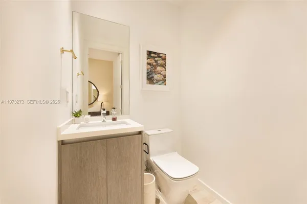 a bathroom with a sink toilet and mirror