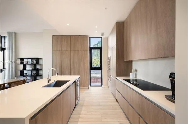 a large kitchen with stainless steel appliances kitchen island granite countertop a sink and cabinets