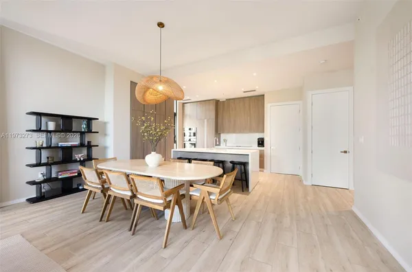 a dining room with a wooden table and chairs