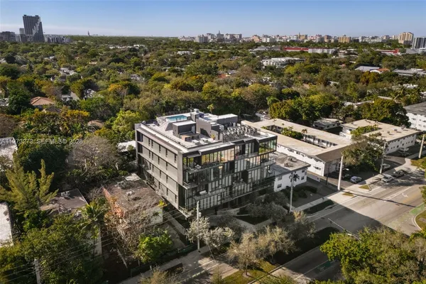 an aerial view of a house with a yard