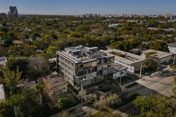 an aerial view of a house with a yard
