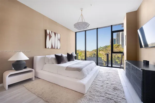 a spacious bedroom with a bed and a large window