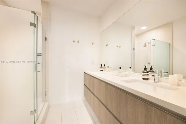 a bathroom with a double vanity sink mirror and